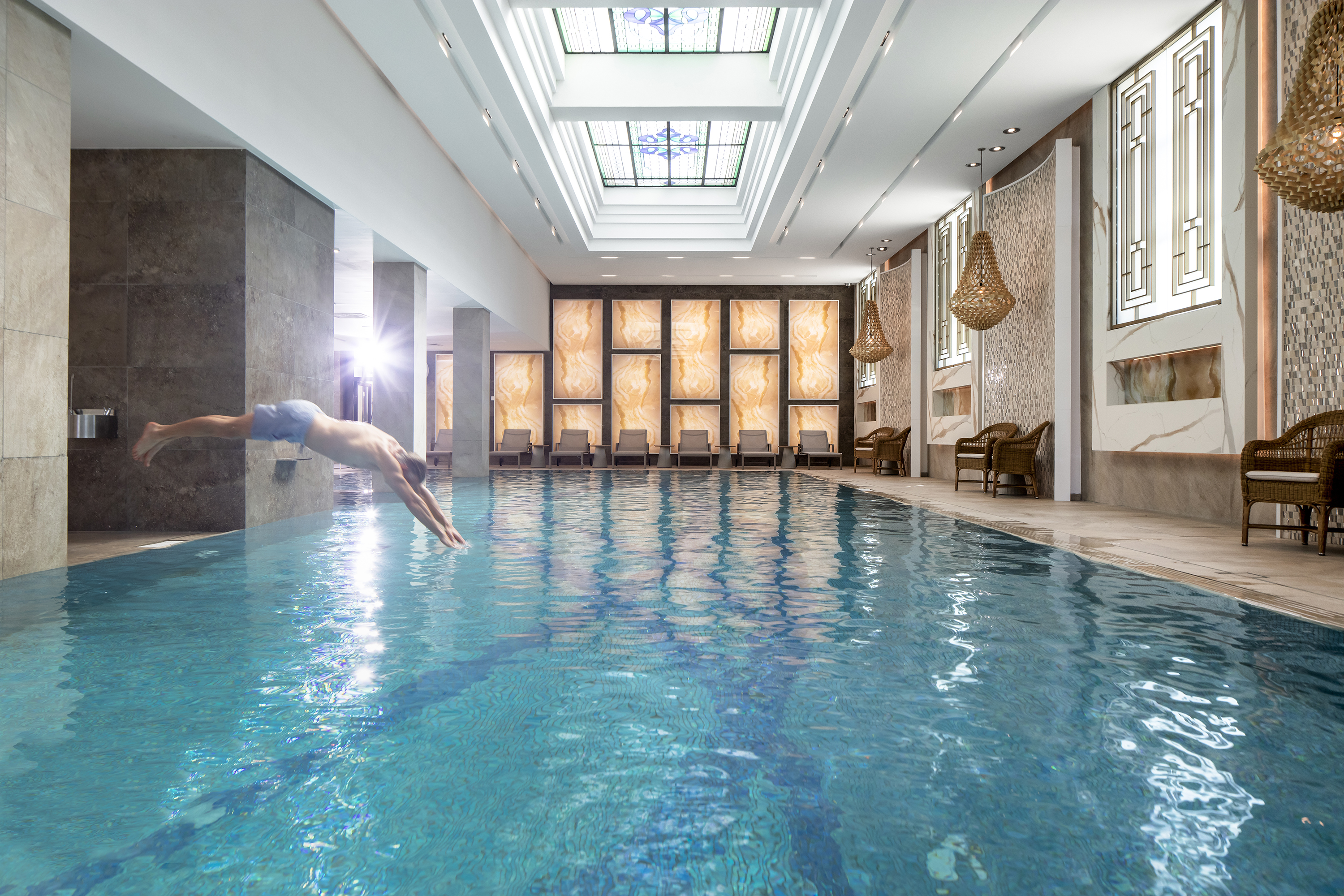 Man jumping into indoor pool