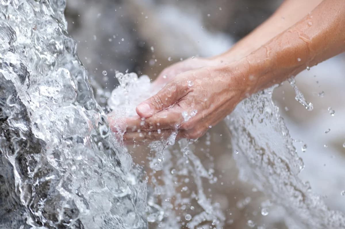hands in the water stream